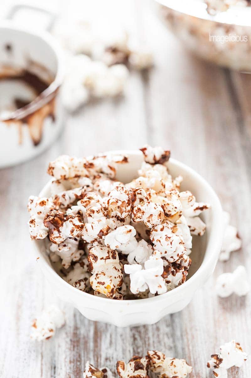 Spicy Chocolate Popcorn is light, airy, and crunchy. Drizzled with sweet melted chocolate with a spicy kick from cayenne pepper and a sprinkling of sea salt. Addicting snack | Imagelicious
