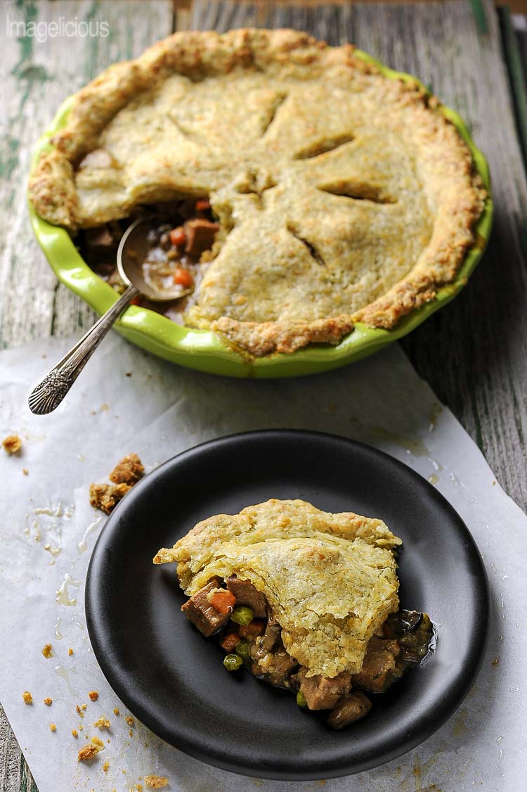 Beef Pot Pie with Cheddar Crust - Soft cubes of meat, melting into silky smooth gravy, studded with bright carrots and peas, mixed with earthy mushrooms, and occasional clove of sweet soft garlic, covered in flakey cheddar pastry with a hint of fresh dill. Perfect to use left over roast | Imagelicious
