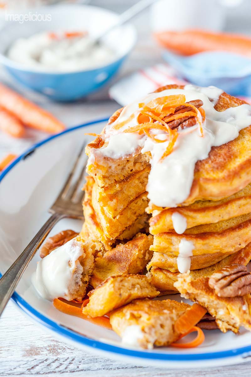 Close up of a stack of Carrot Cake Pancakes with a few pieces cut out