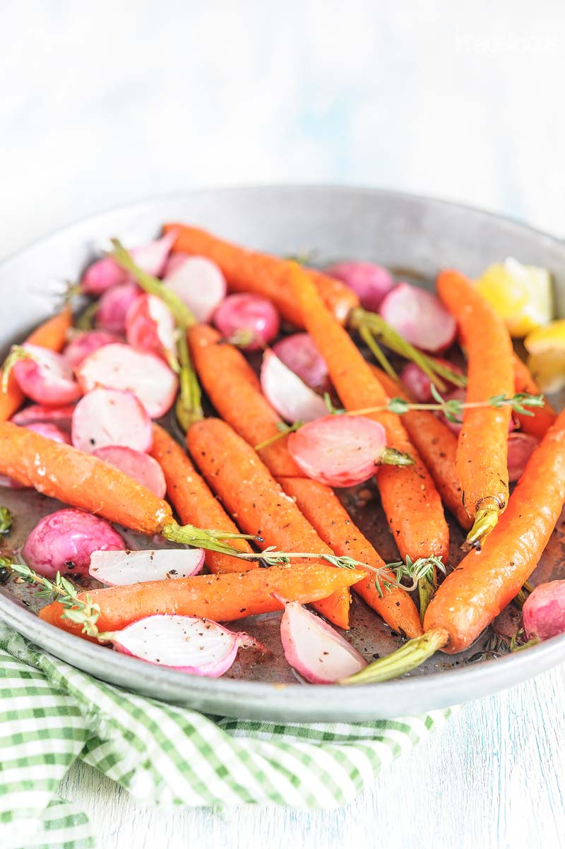Closeup of roasted radishes and carrots