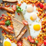 Sheet Pan Full Breakfast is the easiest way to enjoy fried eggs, sweet potato hash brown, breakfast sausages, and toast without using any frying pans. Only a few minutes of prep and full breakfast is cooked in under 30 minutes. Delicious and easy! Perfect for busy weekend mornings | Imagelicious