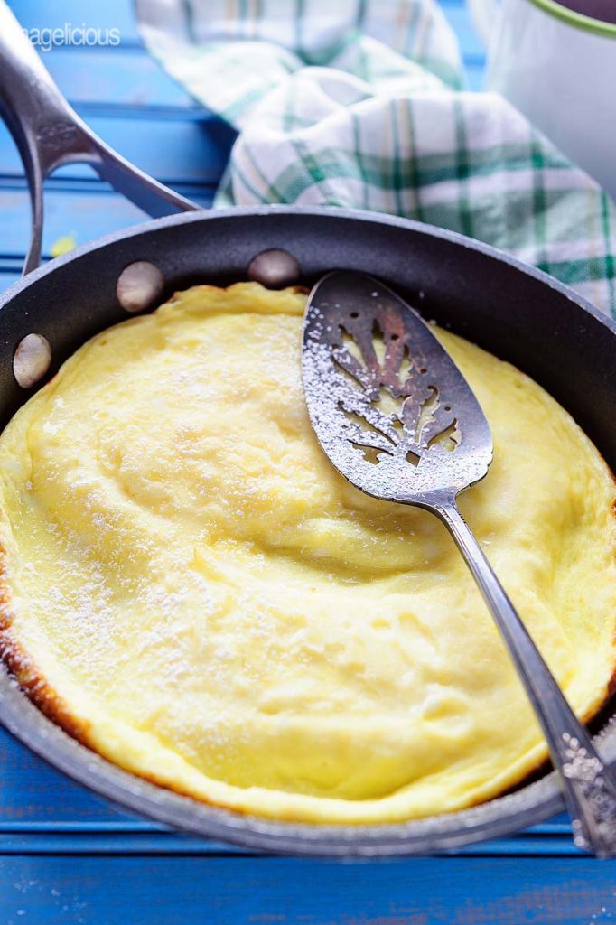Another angle of sweet omelet on a pan with a spatula