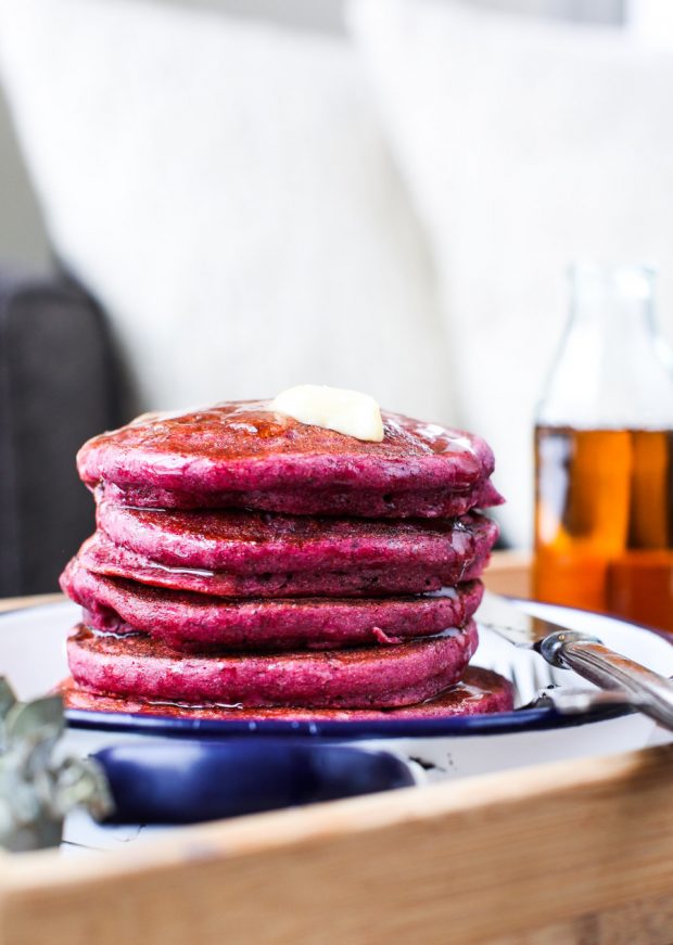 Side view of a plate with a stack of beet pancakes