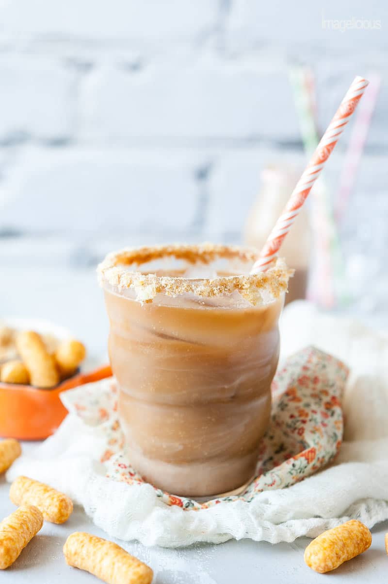 Closeup of a glass filled with Peanut Butter Iced Coffee and a straw
