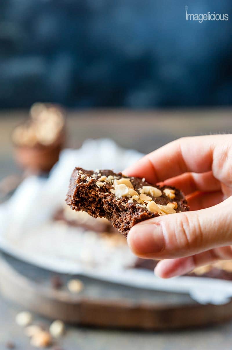 Closeup view of a hand holding a chocolate peanut butter brownie