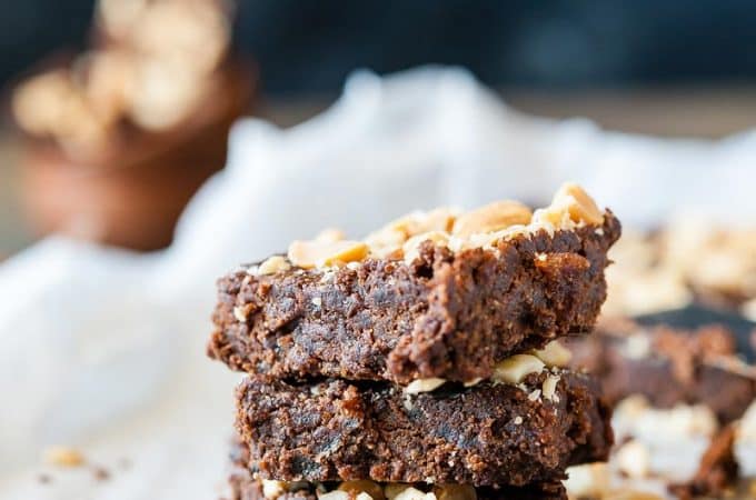 Closeup of three chocolate peanut butter brownies in a stack