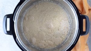Top down view of Instant Pot with the liquid and yeast all foamy