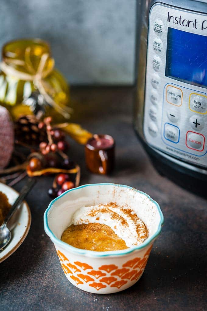 Instant Pot Pumpkin Pudding Cake in a ramekin with an actual Instant Pot appliance visible in the background
