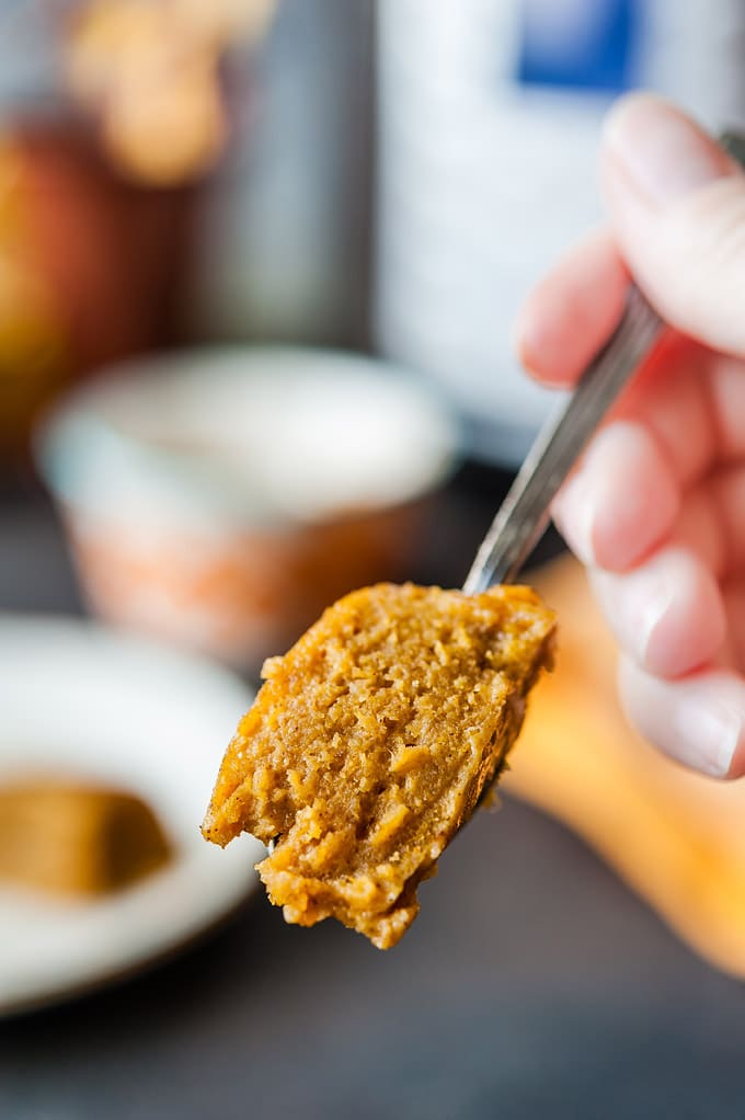Closeup of a spoonful of Instant Pot Pumpkin Pudding Cake held by a hand