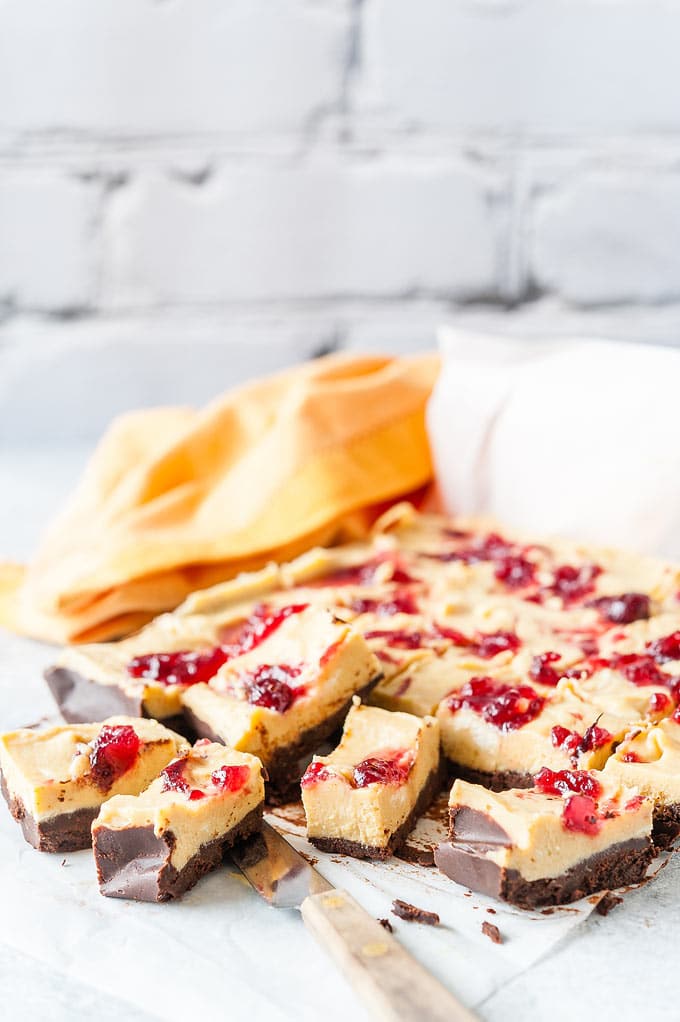 Photo of Pumpkin Cranberry Fudge cut into pieces with a napkin in the background