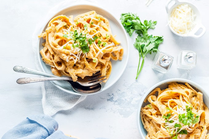 Another top down view of two bowls of Instant Pot Pumpkin Fettuccine Alfredo
