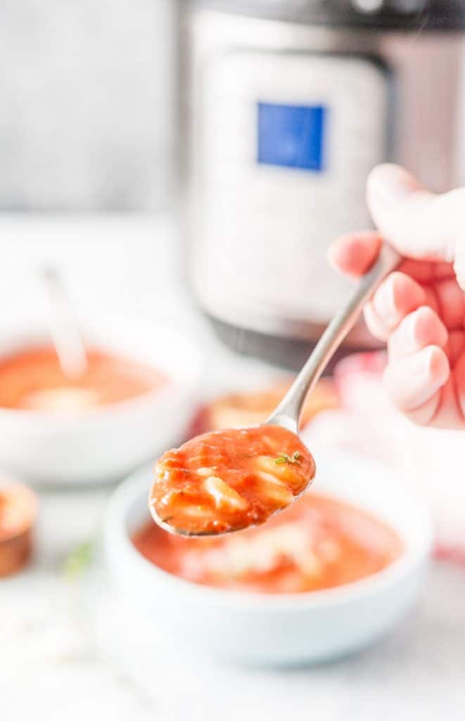 Closeup of a spoon full with Instant Pot Tomato Orzo Soup