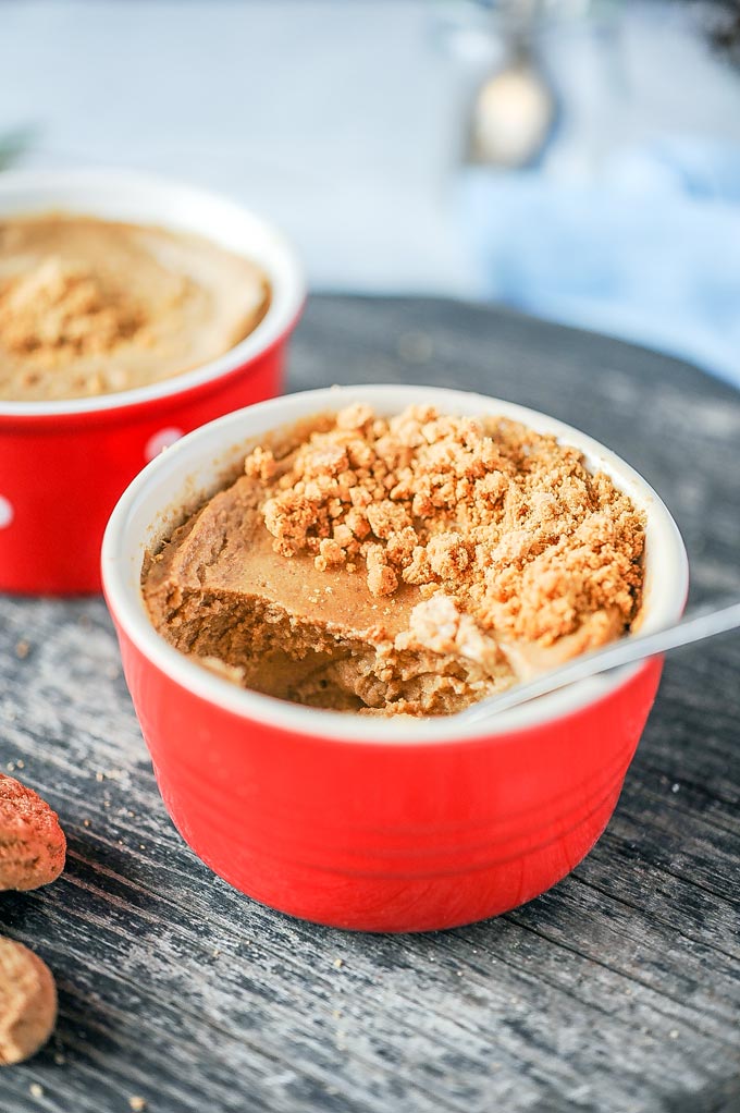 Spoonful inside a red ramekin with Instant Pot Gingerbread Cheesecake