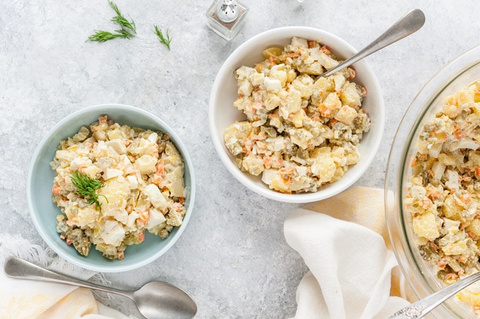 Another view of two bowls of Russian Potato Salad