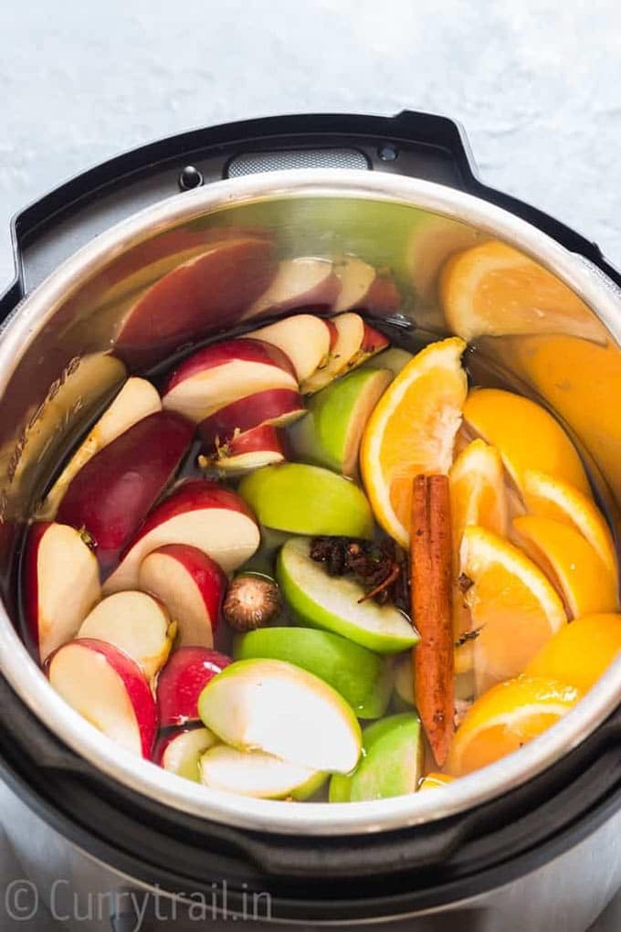 Instant Pot filled with all the ingredients to make apple cider