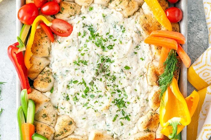 Top down view of a beautiful Sheet Pan Ricotta Crab Biscuit Ring Dip with colourful vegetables tucked around the biscuits