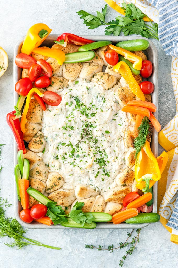Top down view of a beautiful Sheet Pan Ricotta Crab Biscuit Ring Dip with colourful vegetables tucked around the biscuits