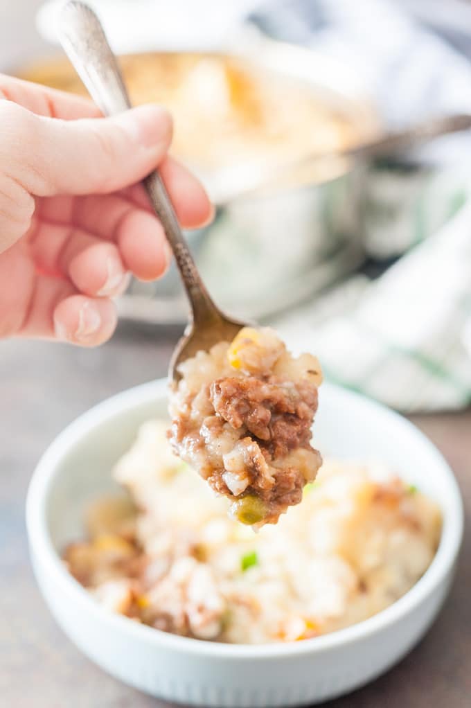 Hand holding a spoonful of Instant Pot Shepherd's Pie