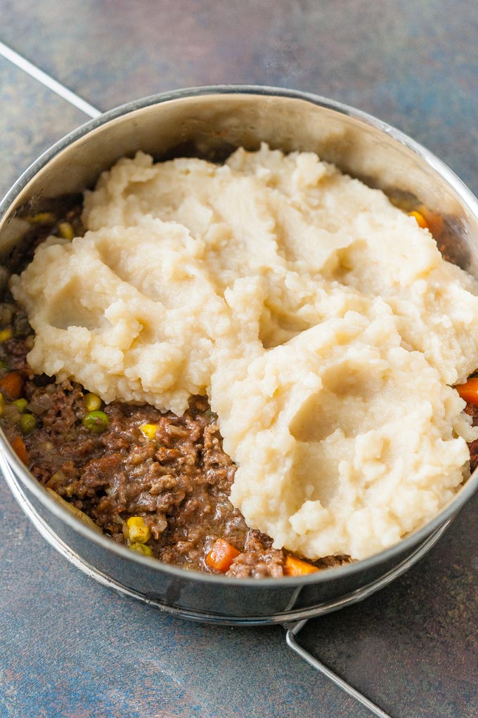 Meat layer partially covered by mashed potatoes