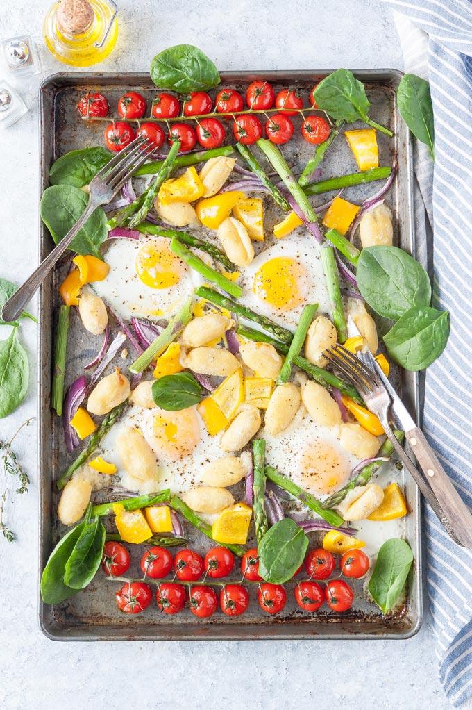 Cooked Gnocchi and Eggs with vegetables on a sheet pan