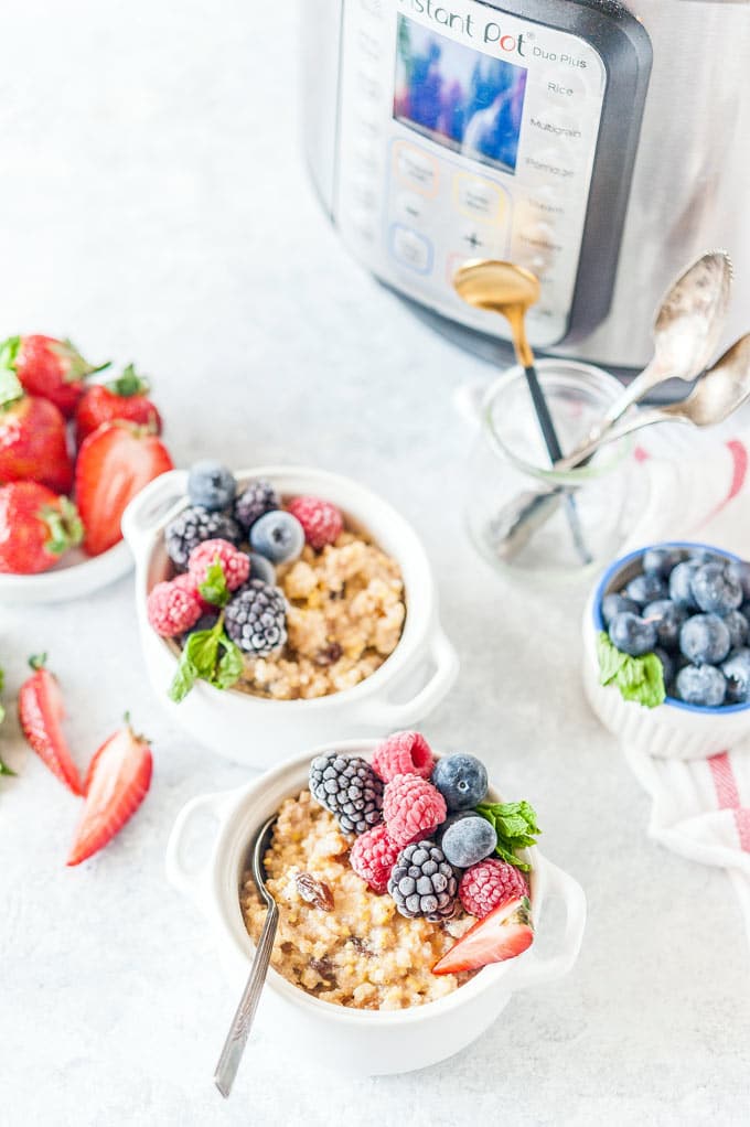 Two small bowls of Instant Pot Millet Porridge with berries