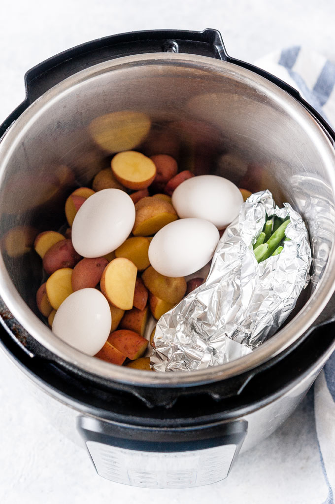 Instant Pot with potatoes, green beans, and eggs.