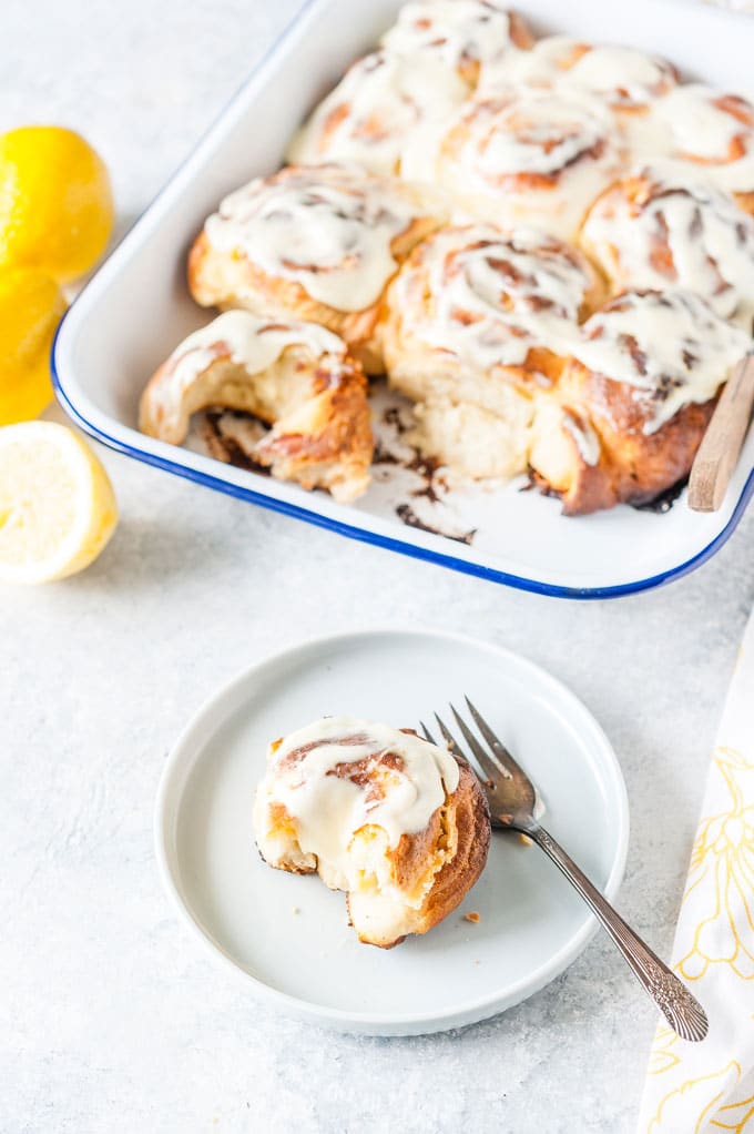 Pan with Lemon Rolls and one roll on a plate.