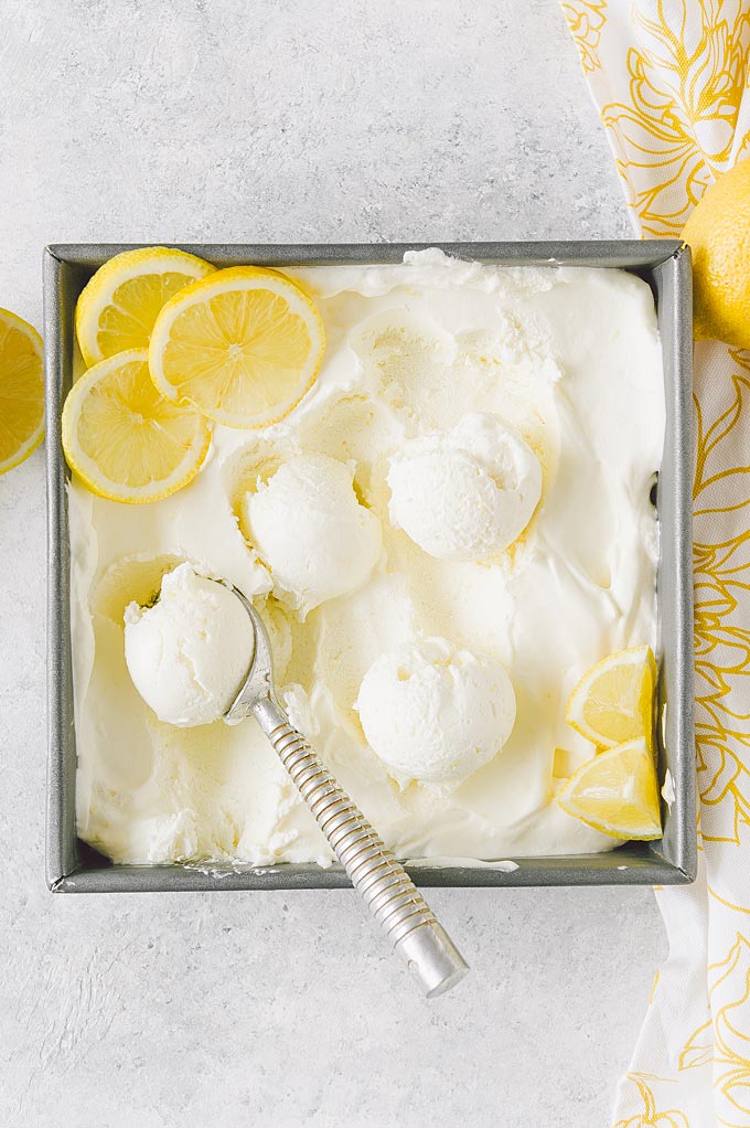Top down view of a container with lemon ice cream.