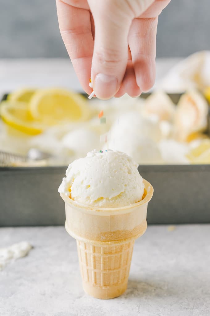 Lemon ice cream cone with sprinkles.