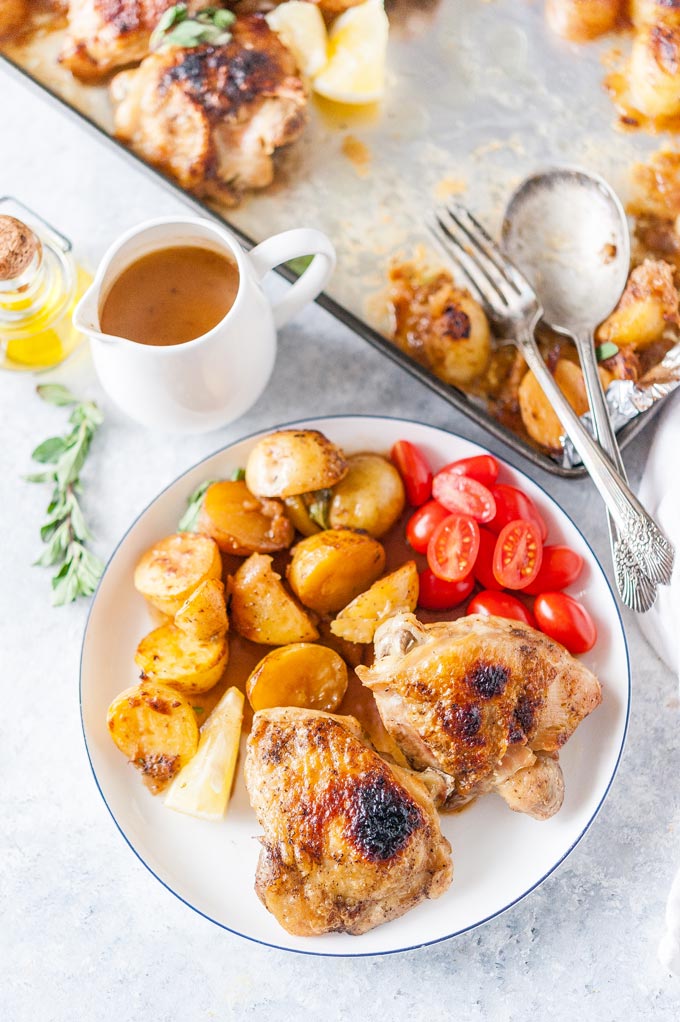 Top down view of a plate with chicken and potatoes.