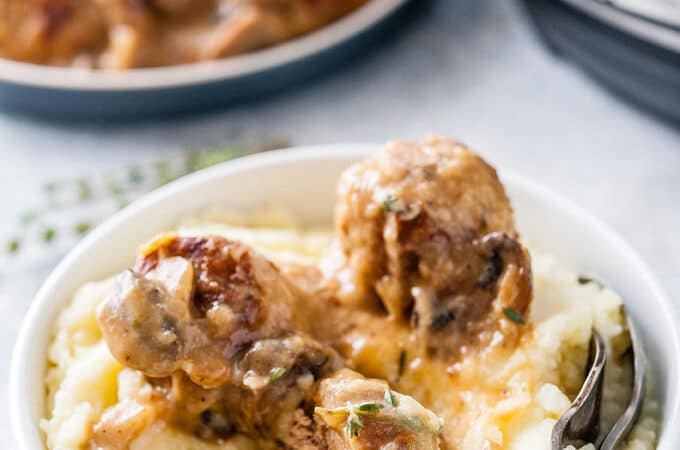 Bowl with mashed potatoes and meatballs.