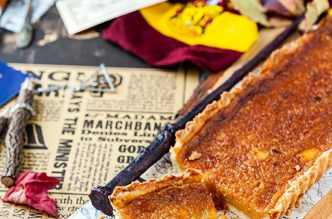 Treacle Tart with a lot of Harry Potter props around it